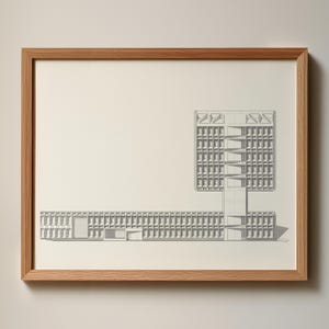 May include: Pencil sketch architectural drawing of a building with a geometric design. The artwork is framed in a light brown wooden frame. The building features a long, low structure connected to a taller, multi-story section with a complex facade.