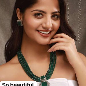 May include: A multi-strand emerald green beaded necklace and matching square earrings with a large square pendant. The pendant and earrings have a silver-colored border and a green center. The text "So beautiful" is at the bottom.