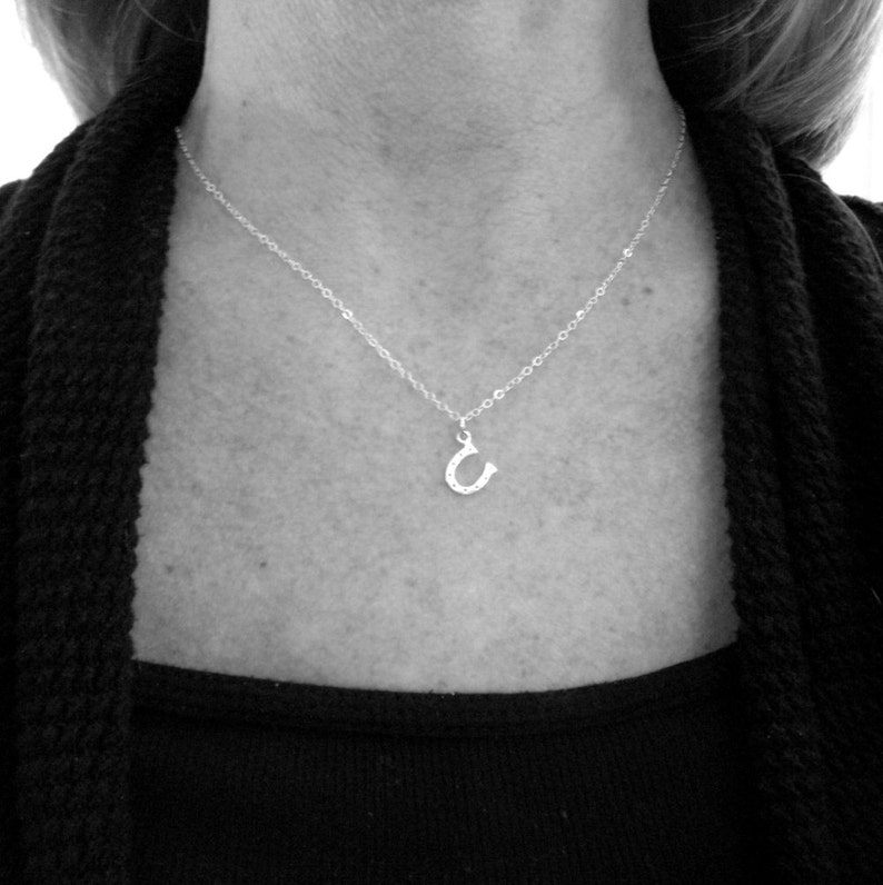 tiny silver horseshoe necklace. lucky charm jewelry. good luck. sterling silver. simple everyday. tiny silver necklace. horse shoe pendant. image 3