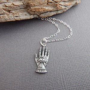 sterling silver hand with eye necklace. small clairvoyance pendant. intuition justice symbol. unique decorative hand. haunting eye charm 3/4