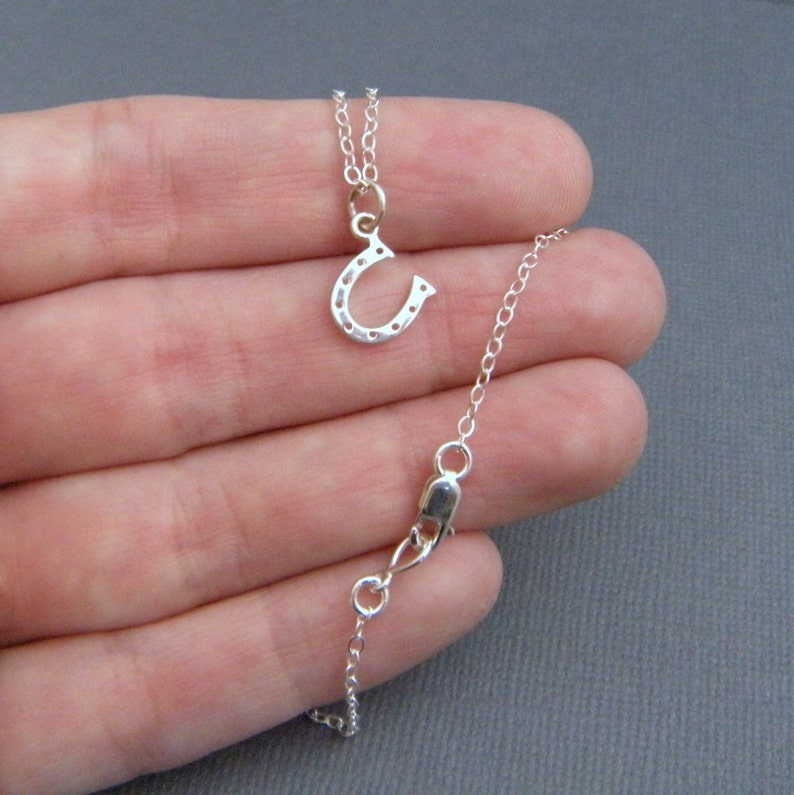 tiny silver horseshoe necklace. lucky charm jewelry. good luck. sterling silver. simple everyday. tiny silver necklace. horse shoe pendant. image 4