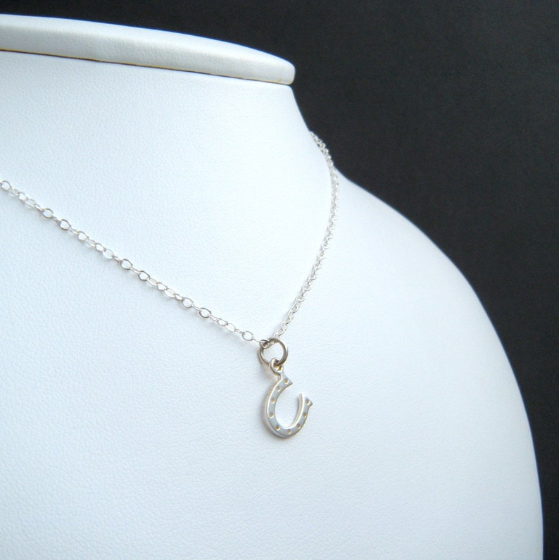 tiny silver horseshoe necklace. lucky charm jewelry. good luck. sterling silver. simple everyday. tiny silver necklace. horse shoe pendant. image 2