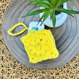 Yellow Crocheted Wireless earbud case, compatible with AirPods, measures 3 T 3 H .25 D, Pretty Raised Flower Granny Square Design