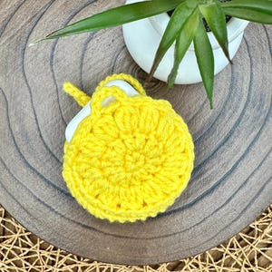 Yellow Crocheted Wireless earbud case, compatible with AirPods, measures 3.5 T 3.5 H .25 D, Pretty Round Design