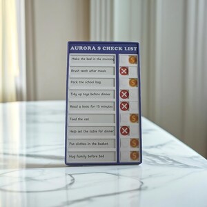 May include: A blue checklist with the title "AURORA'S CHECK LIST" and a list of chores for a child to complete. Each chore has a circle next to it with either an "S" or an "X" inside. The chores include "Make the bed in the morning", "Brush teeth after meals", "Pack the school bag", "Tidy up toys before dinner", "Read a book for 15 minutes", "Feed the cat", "Help set the table for dinner", "Put clothes in the basket", and "Hug family before bed."