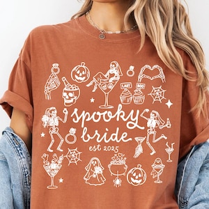 Get spooky in style with this Funny Halloween Bride Shirt — perfect for brides-to-be who love fall vibes and a little gothic glam! Printed on ultra-soft Comfort Colors®, it's ideal for bachelorette parties, Halloween-themed bridal showers, or showing off your spooky bride era. A must-have for future Mrs. who love skeletons, sass, and all things festive!