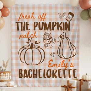 May include: A rectangular fabric backdrop featuring a light orange and white gingham pattern. The text reads fresh off THE PUMPKIN patch Emily's BACHELORETTE. Graphics include two pumpkins, a mug labeled bride, a ring box, and small stars.