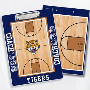 May include: Two navy blue basketball clipboards with a wooden court design. One clipboard features a tiger mascot and the words "COACH LEWIS" and "TIGERS". The other clipboard shows a partial court.