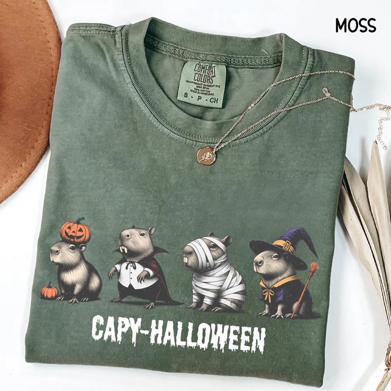 Celebrate spooky season in style with this Halloween Capybara Social Club shirt — perfect for anyone who loves retro vibes, chill capybara energy, and a touch of festive flair! Printed on ultra-soft Comfort Colors®, this Halloween t-shirt is a must-have for fall. Whether you’re rocking a spooky and cute look, a pumpkin capybara tee, or a playful ghost capybara vibe, this design blends cozy comfort with trendy social club style for the ultimate autumn statement.