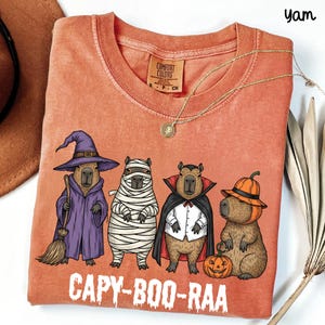 Celebrate spooky season in style with this Halloween Capybara Social Club shirt — perfect for anyone who loves retro vibes, chill capybara energy, and a touch of festive flair! Printed on ultra-soft Comfort Colors®, this Halloween t-shirt is a must-have for fall. Whether you’re rocking a spooky and cute look, a pumpkin capybara tee, or a playful ghost capybara vibe, this design blends cozy comfort with trendy social club style for the ultimate autumn statement.