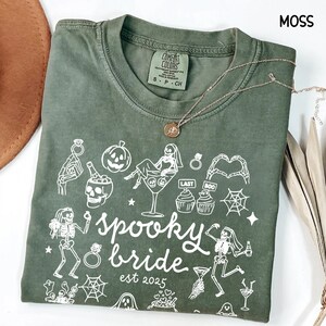 Get spooky in style with this Funny Halloween Bride Shirt — perfect for brides-to-be who love fall vibes and a little gothic glam! Printed on ultra-soft Comfort Colors®, it's ideal for bachelorette parties, Halloween-themed bridal showers, or showing off your spooky bride era. A must-have for future Mrs. who love skeletons, sass, and all things festive!