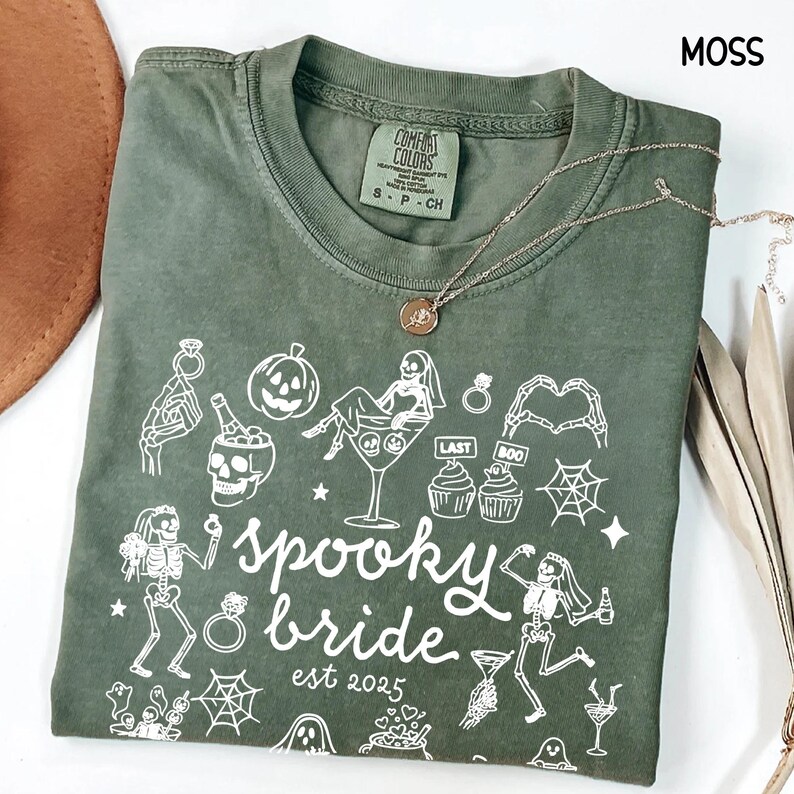 Get spooky in style with this Funny Halloween Bride Shirt — perfect for brides-to-be who love fall vibes and a little gothic glam! Printed on ultra-soft Comfort Colors®, it's ideal for bachelorette parties, Halloween-themed bridal showers, or showing off your spooky bride era. A must-have for future Mrs. who love skeletons, sass, and all things festive!