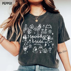 Get spooky in style with this Funny Halloween Bride Shirt — perfect for brides-to-be who love fall vibes and a little gothic glam! Printed on ultra-soft Comfort Colors®, it's ideal for bachelorette parties, Halloween-themed bridal showers, or showing off your spooky bride era. A must-have for future Mrs. who love skeletons, sass, and all things festive!