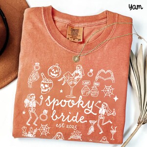 Get spooky in style with this Funny Halloween Bride Shirt — perfect for brides-to-be who love fall vibes and a little gothic glam! Printed on ultra-soft Comfort Colors®, it's ideal for bachelorette parties, Halloween-themed bridal showers, or showing off your spooky bride era. A must-have for future Mrs. who love skeletons, sass, and all things festive!