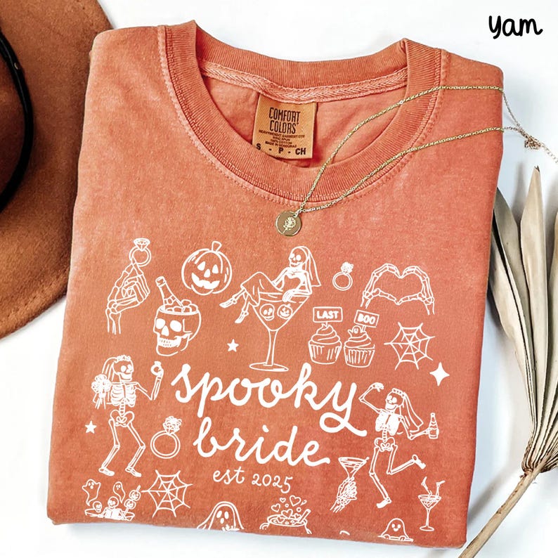 Get spooky in style with this Funny Halloween Bride Shirt — perfect for brides-to-be who love fall vibes and a little gothic glam! Printed on ultra-soft Comfort Colors®, it's ideal for bachelorette parties, Halloween-themed bridal showers, or showing off your spooky bride era. A must-have for future Mrs. who love skeletons, sass, and all things festive!
