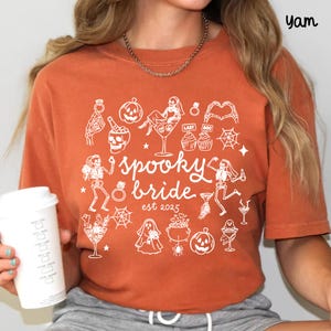 Get spooky in style with this Funny Halloween Bride Shirt — perfect for brides-to-be who love fall vibes and a little gothic glam! Printed on ultra-soft Comfort Colors®, it's ideal for bachelorette parties, Halloween-themed bridal showers, or showing off your spooky bride era. A must-have for future Mrs. who love skeletons, sass, and all things festive!