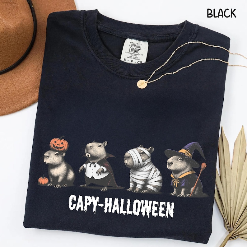 Celebrate spooky season in style with this Halloween Capybara Social Club shirt — perfect for anyone who loves retro vibes, chill capybara energy, and a touch of festive flair! Printed on ultra-soft Comfort Colors®, this Halloween t-shirt is a must-have for fall. Whether you’re rocking a spooky and cute look, a pumpkin capybara tee, or a playful ghost capybara vibe, this design blends cozy comfort with trendy social club style for the ultimate autumn statement.