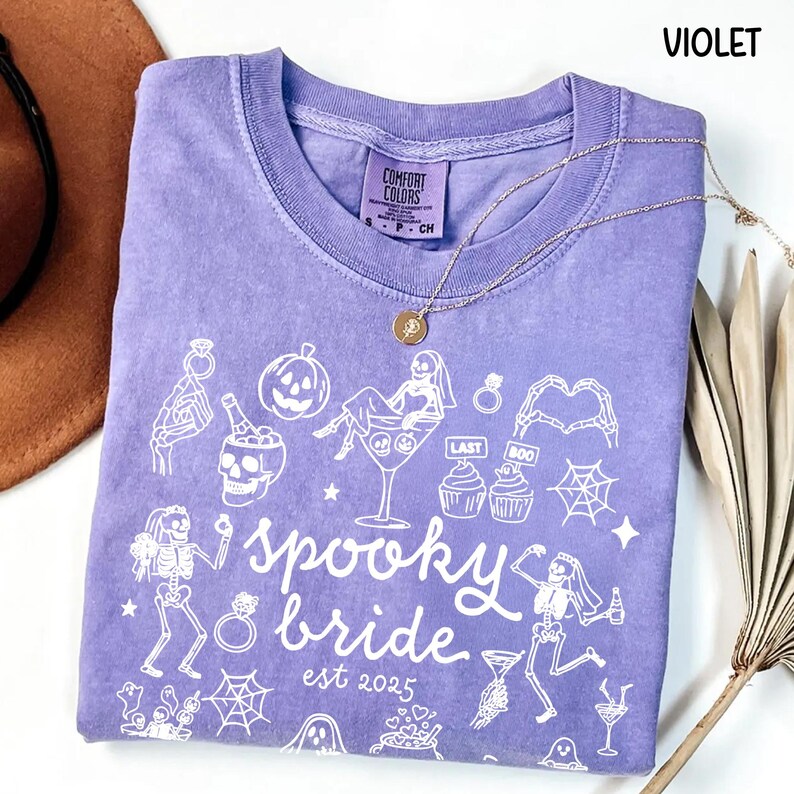Get spooky in style with this Funny Halloween Bride Shirt — perfect for brides-to-be who love fall vibes and a little gothic glam! Printed on ultra-soft Comfort Colors®, it's ideal for bachelorette parties, Halloween-themed bridal showers, or showing off your spooky bride era. A must-have for future Mrs. who love skeletons, sass, and all things festive!