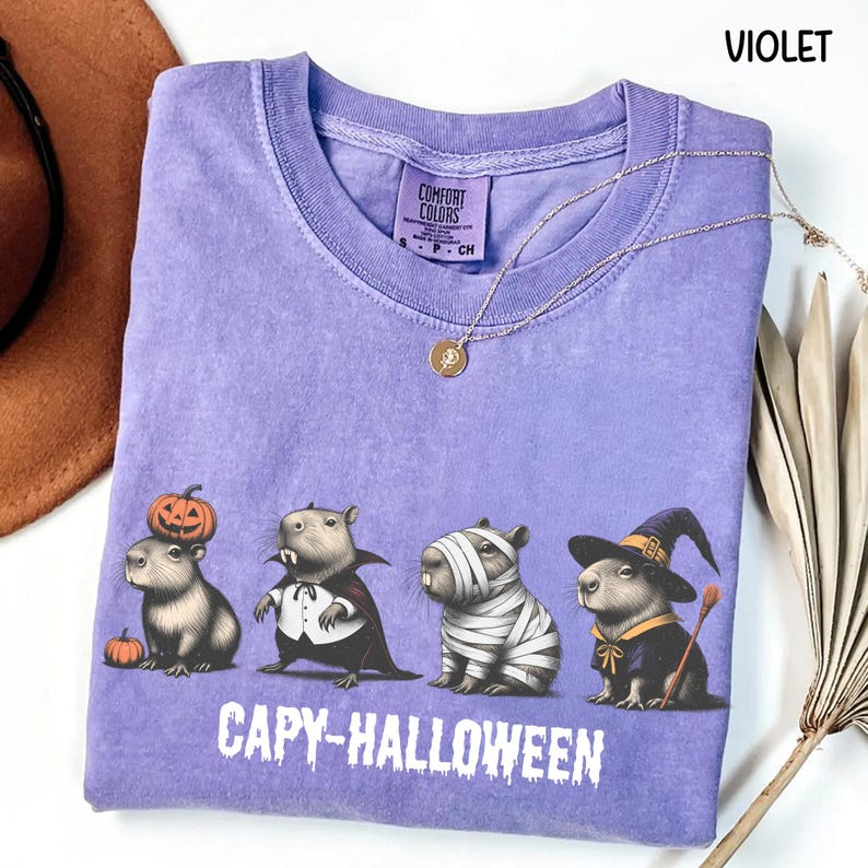 Celebrate spooky season in style with this Halloween Capybara Social Club shirt — perfect for anyone who loves retro vibes, chill capybara energy, and a touch of festive flair! Printed on ultra-soft Comfort Colors®, this Halloween t-shirt is a must-have for fall. Whether you’re rocking a spooky and cute look, a pumpkin capybara tee, or a playful ghost capybara vibe, this design blends cozy comfort with trendy social club style for the ultimate autumn statement.