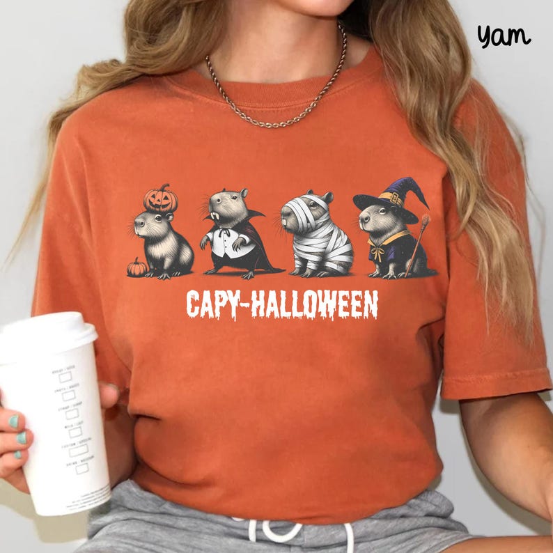 Celebrate spooky season in style with this Halloween Capybara Social Club shirt — perfect for anyone who loves retro vibes, chill capybara energy, and a touch of festive flair! Printed on ultra-soft Comfort Colors®, this Halloween t-shirt is a must-have for fall. Whether you’re rocking a spooky and cute look, a pumpkin capybara tee, or a playful ghost capybara vibe, this design blends cozy comfort with trendy social club style for the ultimate autumn statement.