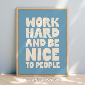 May include: A blue framed print with the text "Work hard and be nice to people" in white lettering.