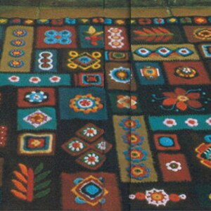 May include: A vibrant, handmade rug featuring a repeating pattern of geometric and floral motifs in teal, brown, orange, and yellow. The rug has a dark background and the text "Crochet and Felt Rug Pattern #R27".