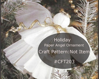 May include: A white paper angel ornament with gold accents, displayed on a Christmas tree. The angel has a halo and a ribbon. Text on the image reads "Holiday Paper Angel Ornament Craft Pattern: Not Item #CFT203".