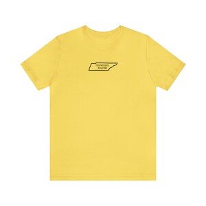 May include: Yellow short-sleeved t-shirt with a black outline of the state of Tennessee and the text "Tennessee Educated" inside the outline.