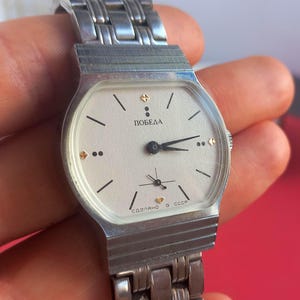 Rare Soviet “Pobeda” mechanical watch with strap, fully manual, ships from Ukraine in 24 h.

I first found this “Stalin’s Falcon” tucked in a tiny wooden box at a Kyiv flea market. The dial immediately caught my eye—bold, vintage, and somehow heroic. I wound the crown and the hands sprang to life with that steady tick-tock you can only get from a true mechanical watch. Holding it felt like gripping a tiny piece of history, a watch that’s seen decades yet still proudly ticks away.