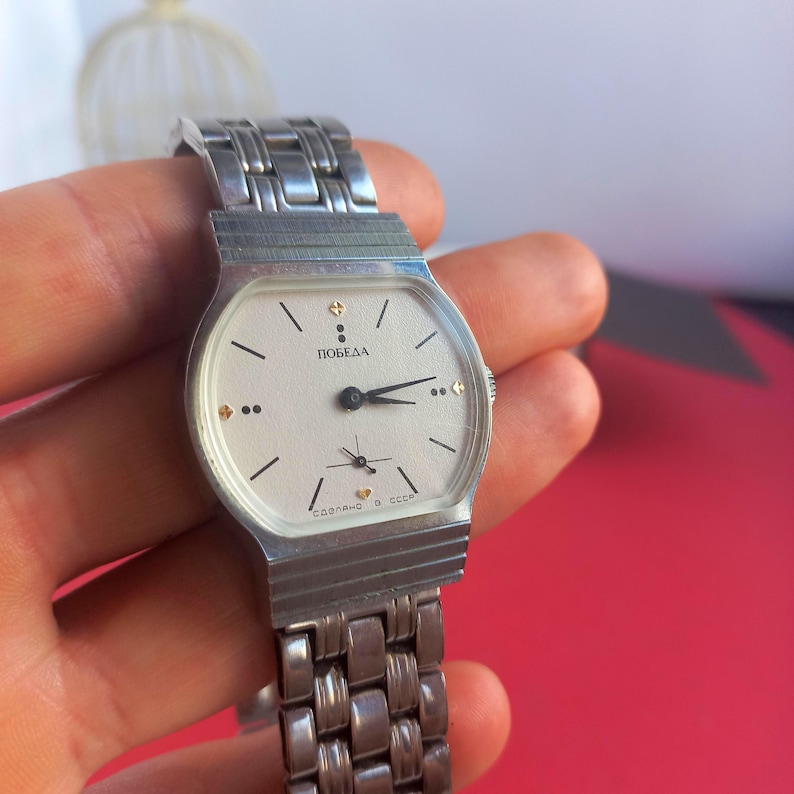 Rare Soviet “Pobeda” mechanical watch with strap, fully manual, ships from Ukraine in 24 h.

I first found this “Stalin’s Falcon” tucked in a tiny wooden box at a Kyiv flea market. The dial immediately caught my eye—bold, vintage, and somehow heroic. I wound the crown and the hands sprang to life with that steady tick-tock you can only get from a true mechanical watch. Holding it felt like gripping a tiny piece of history, a watch that’s seen decades yet still proudly ticks away.