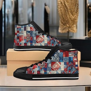 May include: A pair of high-top canvas shoes with a colorful geometric pattern in shades of red, blue, and white. The shoes have black laces and a black rubber sole.
