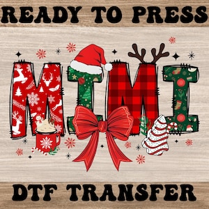May include: A Christmas-themed DTF transfer design with the word "MIMI" in festive patterns. The letters are decorated with reindeer, snowflakes, and plaid. A red bow, Santa hat, and Christmas tree complete the design. The words "READY TO PRESS" and "DTF TRANSFER" are at the top and bottom.