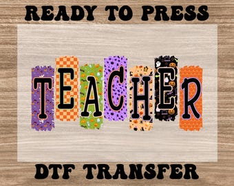 May include: A DTF transfer design with the word "TEACHER" in black letters. Each letter has a unique pattern, including orange checkerboard, green with ghosts, and purple with dots. The words "READY TO PRESS" and "DTF TRANSFER" are also in the image.