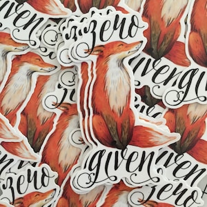 May include: A stack of stickers featuring a fox illustration with the text "given zero" in a stylized font. The fox is orange and white with a black nose and eyes. The stickers are printed on white paper.