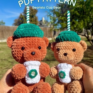 May include: Two crochet teddy bears, each with a green hat and a white cup with a green logo. The bears are brown and tan, with black eyes and a striped straw. The text "PDF PATTERN Bearista Cup Bear" is at the top.
