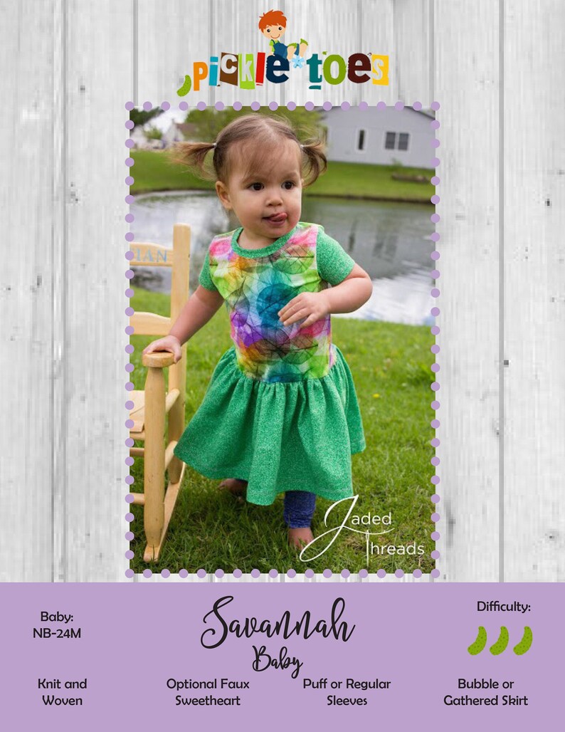 May include: A green and rainbow patterned baby dress with a gathered skirt. The dress has puff sleeves and is labeled "Savannah Baby".