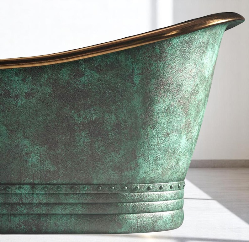 May include: Close-up of a green and bronze bathtub. The tub has a textured finish with a bronze rim. The exterior features horizontal bands with rivets. The overall design suggests a vintage or antique aesthetic.