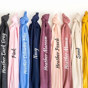 a bunch of different colored ties hanging on a wall