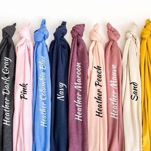 a bunch of different colored ties hanging on a wall