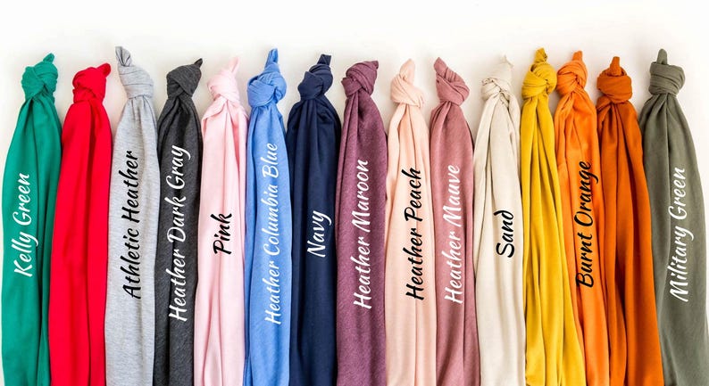 a bunch of different colored ties hanging on a wall