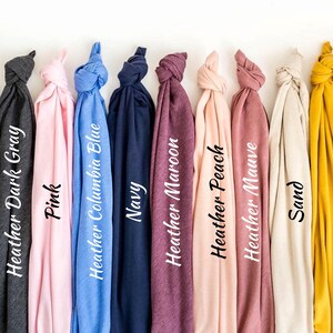 a bunch of different colored ties hanging on a wall