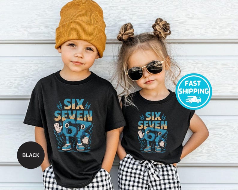 May include: Two children wearing black t-shirts with the text "SIX SEVEN" in blue and orange. The graphic features a cartoon number 67 character. One child wears a mustard yellow beanie, the other wears sunglasses. Both are wearing black and white checkered pants.