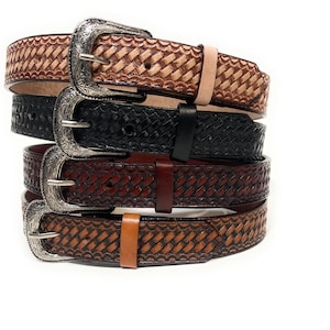 May include: Four leather belts with silver buckles. The belts are stacked on top of each other. The belts are all different colors, including brown, black, and tan. The belts have a woven design.