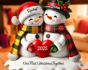 May include: A snowman couple Christmas ornament. One snowman wears a red Santa hat with the name "Rachel", and the other wears a black top hat with the name "James". They hold a red heart with "2025" on it. The ornament reads "Our First Christmas Together".