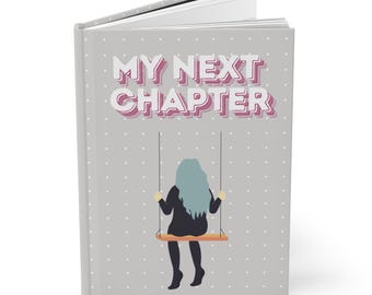 May include: A gray journal with a white polka dot pattern. The front cover features the text "MY NEXT CHAPTER" in pink and white letters. A silhouette of a person with blue hair is sitting on a swing.