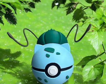 May include: A blue and green Pokemon character, resembling a turtle, with a Pokeball design on its shell. The character has two long, thin antennae.