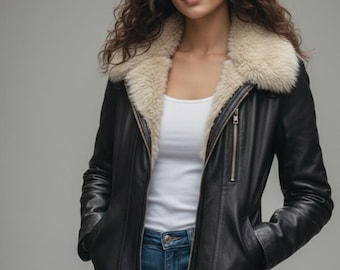 May include: A black leather jacket with a cream-colored shearling collar. The jacket has a zipper closure, pockets, and a tailored fit. The model is wearing a white tank top and blue jeans.