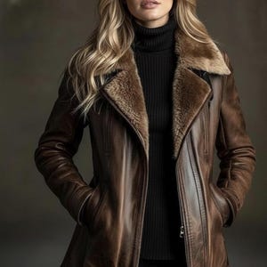 May include: A brown leather jacket with a shearling collar and a black turtleneck. The jacket has a zipper closure and pockets. The model is wearing the jacket and has blonde hair.