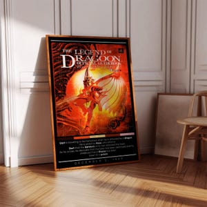 May include: A poster for the video game The Legend of Dragoon. The poster features a character in red armor with a large, fiery wing. The text on the poster reads "The Legend of Dragoon Official Guidebook" and "December 2, 1999".