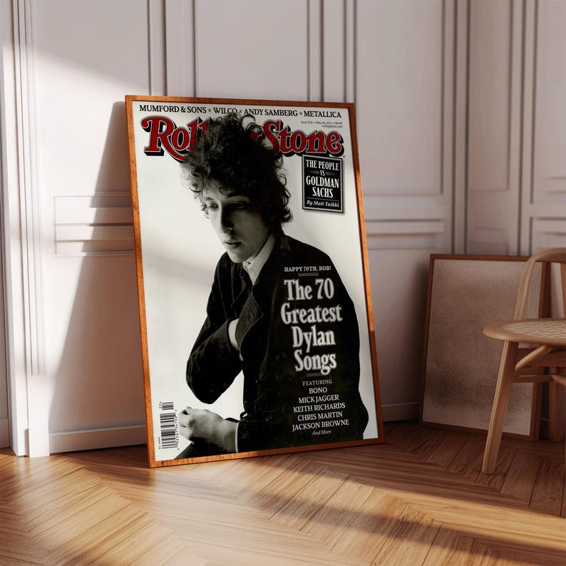 May include: A vintage Rolling Stone magazine cover featuring Bob Dylan. The cover is red and white with the title "The 70 Greatest Dylan Songs" and features a black and white photo of Bob Dylan.
